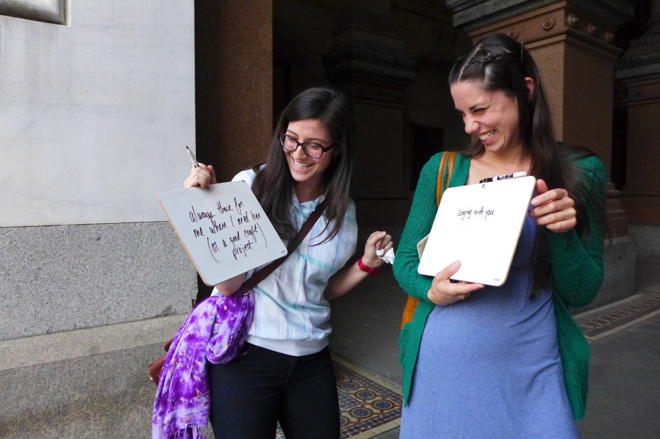 Philadelphia Becky and Sara (friends) laughing at signs
