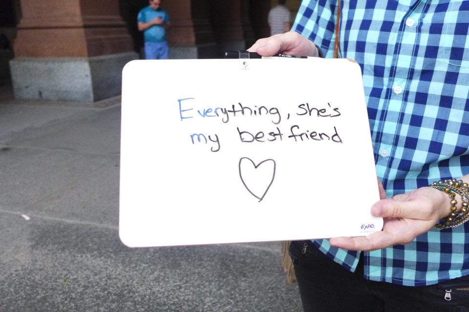 Philadelphia Tracy and Arieln close up on sign